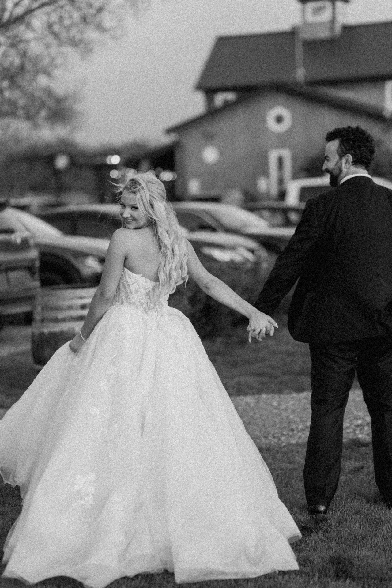 Bride and groom holding hands at golden hour