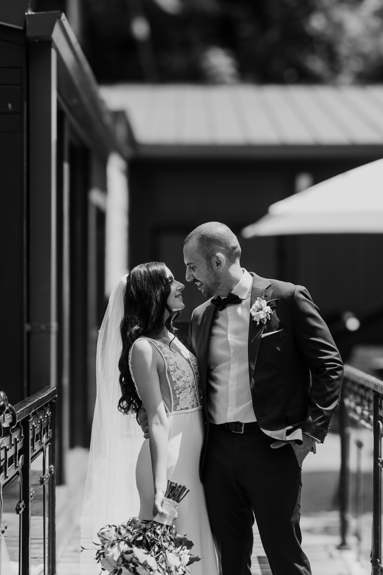Black and white portrait of bride and groom smiling
