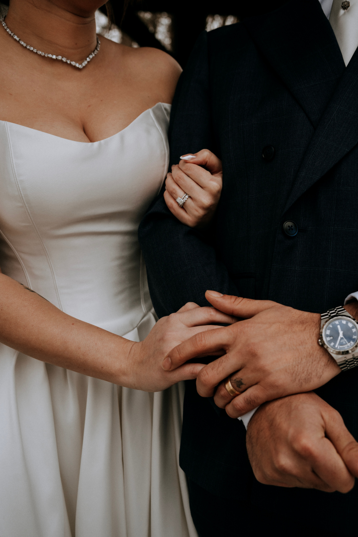 Close-up of couple's rings and hands