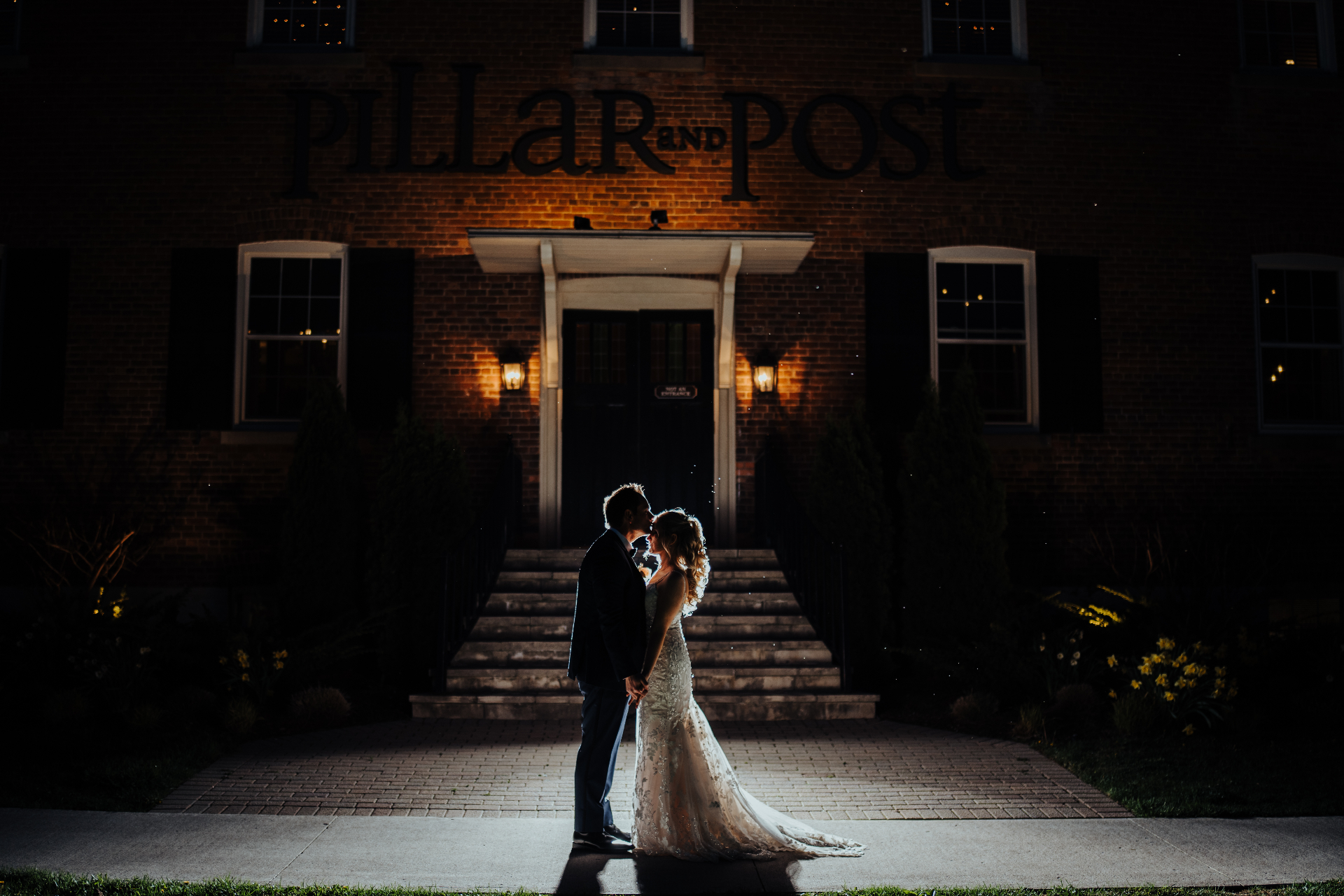 Couple silhouetted outside Pillar and Post at night