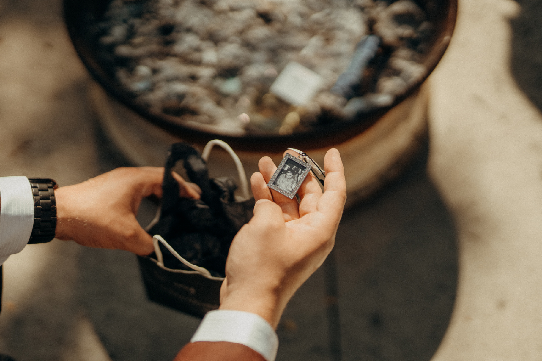 Groom holding a family photo keepsake